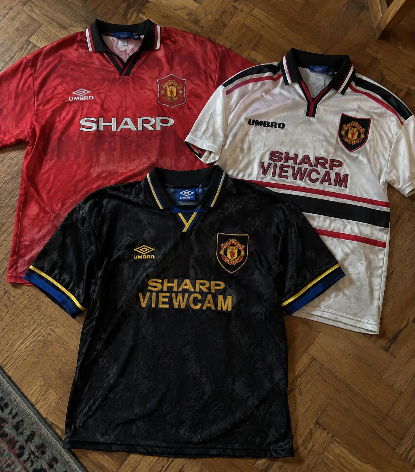 Vintage football jerseys laid out on a wooden floor